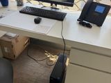 a desk with a computer and a phone on it