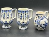 three blue and white vases sitting next to each other on a table