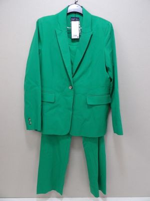 a green suit hanging on a wall next to a hanger