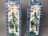 pair of chinese blue and white vases with figures on them
