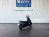 a motorcycle that is parked in front of a sign
