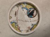 a paper plate with a map on it on a table