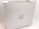 an apple computer sitting on top of a white table