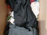 a box full of clothes that is sitting on the floor