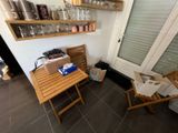 a wooden table with a laptop on it in the corner of a room