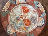 a plate that has a bird on it on a table