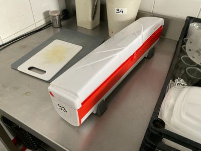 a white and red food warmer sitting on a kitchen counter