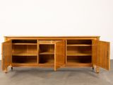 an image of a wooden cabinet with open doors and shelves