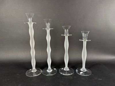 trois bougeoirs en verre transparent sont posés les uns à côté des autres