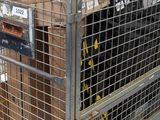 a large metal cage with a bunch of boxes on it