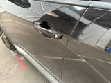 a close up of a car door handle with a hole in it