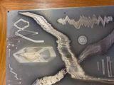 a picture of a picture of a metal object with a bird on it