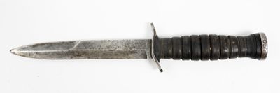 a knife that is laying on top of a white surface