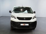 the white van is parked in a large room with a black floor