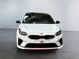 the front view of a white car in a showroom