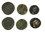 six pièces de monnaie romaines sont alignées sur une surface blanche