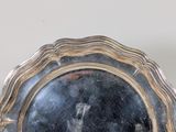 a silver plate with a picture of a man on it
