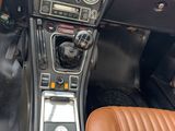 a dashboard of a sports car with leather seats and dashboard controls