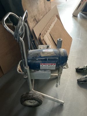 a machine that is sitting on the floor next to a pair of shoes
