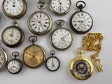 many different types of pocket watches displayed on a white surface