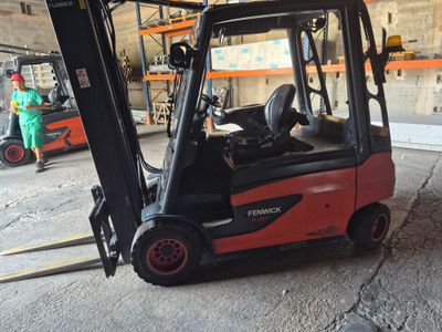 a red fork truck that is parked in a warehouse