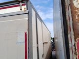 a truck that is parked next to a red and white building