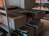 many boxes that are stacked on a shelf in a room