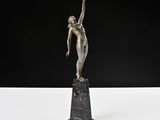 a bronze statue of a woman holding a bird on a pedestal