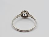 a close up of a ring with a diamond on it
