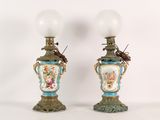 pair of antique lamps with painted vases on them on a white background