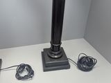 the lamp is on the table next to the charger and cords