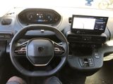 someone is sitting in the driver ' s seat of a car with their feet on the steering wheel