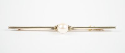 a close up of a white pearl hair pin on a white background