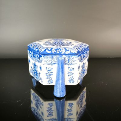 a small blue and white box on a black table