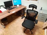 a desk with a chair and a computer on it