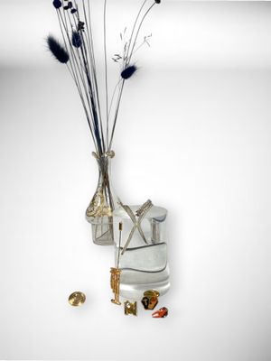 a vase of flowers and a pair of ice skates on a table