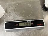 a digital scale sitting on top of a kitchen counter
