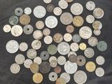 some of the coins are on a black cloth with a black background