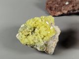 a piece of rock with a yellow substance on top of it