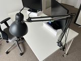 a desk with a chair and a computer monitor on it