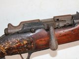an old rifle with a wooden barrel and a metal handle