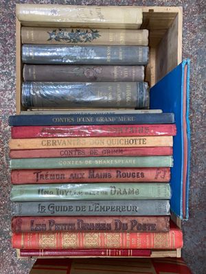 many books stacked on top of each other in a box