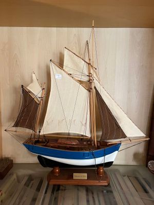 a model of a sailboat on display in a glass case