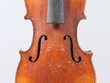 an old violin with a bow hanging from it ' s back