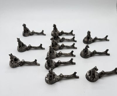 a lot of figurines of people sitting on the ground
