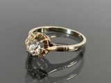 an image of a diamond ring on a black surface