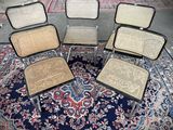 four chairs sitting in a circle on top of a rug