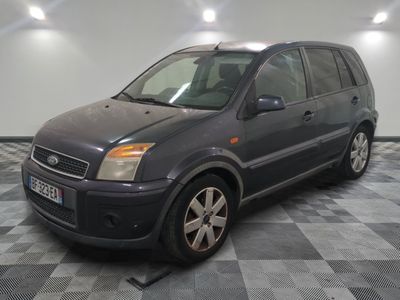 a picture of a grey car that is parked in a garage