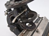 a close up of an old typewriter on a white surface