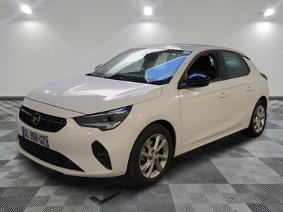 la voiture blanche est garée sur un sol en damier dans le garage